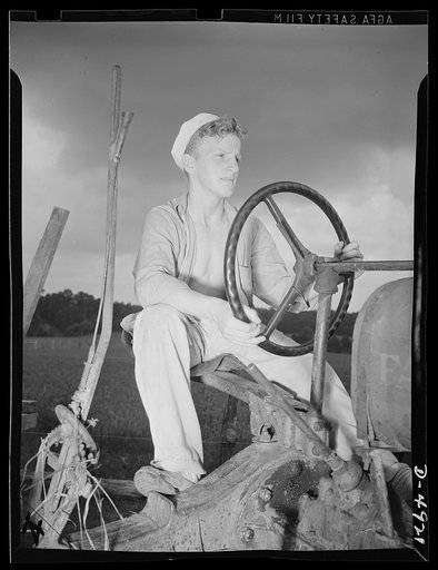 School boys training for agriculture. Carroll Dawn is too young to be in the Army, but he's just as important on this tractor as he'd be in a tank, for as Secretary of Agriculture Vickard says, "Food will win the war and write the peace."
