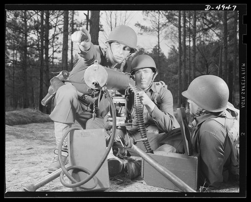 Fort Benning machine gunners. These boys have learned some tricks to show the Axis. This machine gun crew is finishing a sharpening-up course at Fort Benning, Georgia