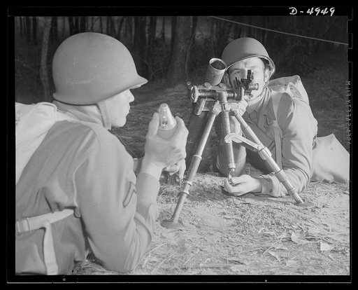 Fort Benning. 60 mm. mortars.  A couple of experts at slowing up the Axis timetable. These two members of a machine gun crew doing post-graduate work at Fort Benning, Georgia with a 60 mm. mortar. It's a piece that can do a lot of damage, and they know how to use it