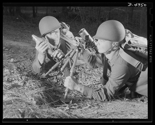 Fort Benning 60 mm. mortars. A couple of experts at slowing up the Axis timetable. These men are doing post-graduate work at Fort Benning, Gerogia with a 60 mm. mortar. It's a piece that can do a lot of damage, and they know how to use it