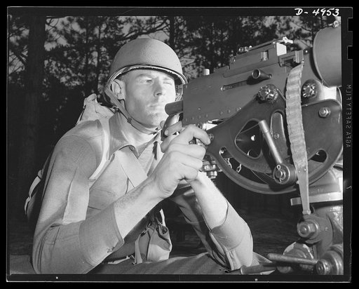 Fort Benning machine gunners. He'll soon be an unpopular figure in Berlin and Tokyo circles. An American machine gunner finishing an intensive training course at Fort Benning, Georgia