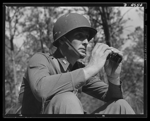 Fort Benning machine gunners. Lieutenant of a machine gun outfit and a keen, capable soldier. He is studying the factor of a military problem at Fort Benning, Georgia
