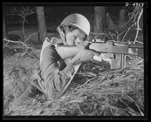Fort Benning infantry. Slow down, Adolph. The road ahead is blocked. When this fine American soldier, just finishing a hardening up course at Fort Benning, Georgia, gives you the red light, remember he's an expert at stopping traffic