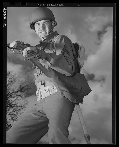 Fort Benning infantry. Slow down, Adolph. The road ahead is blocked. When this fine American soldier, just finishing a hardening up course at Fort Benning, Georgia, gives you the red light, remember he's an expert at stopping traffic