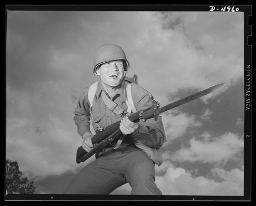 Fort Benning infantry. Slow down, Adolph. The road ahead is blocked. When this fine American soldier, just finishing a hardening up course at Fort Benning, Georgia, gives you the red light, remember he's an expert at stopping traffic