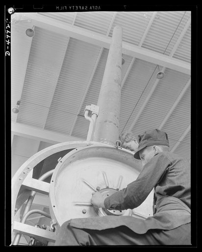 Production. Naval gun mounts. A naval gun mount assembly, one of many produced in a Midwest plant, is carefully inspected before shipment to an undisclosed destination. Westinghouse, Louisville, Kentucky