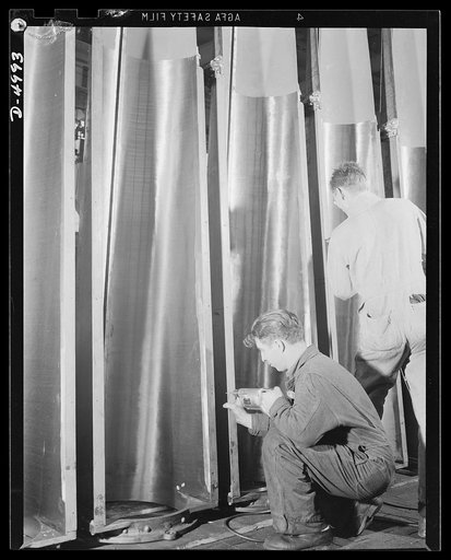 Production. Torpedo tube mounts. Front pieces of torpedo tubes are drilled for assembly in a Midwest plant producing great numbers of mounts for torpedo tubes and large naval guns. Westinghouse, Louisville