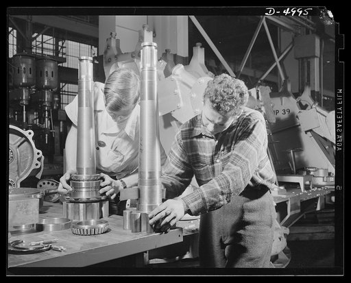 Production. Naval gun mounts. Getting pinions on a naval gun mount assembly. The large Midwest plant producing these mounts in great quantities is also making many torpedo tube mounts. Westinghouse, Louisville