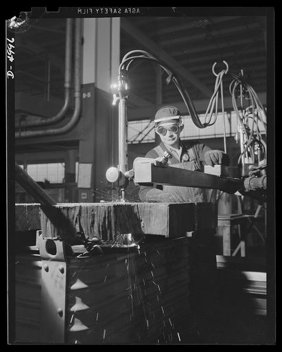 Production. Naval gun mounts. Rough-cutting a steel plate for naval gun mounts. The acetylene flame-cutting methods of a large Midwest plant are a substantial help in keeping production at a high level. Westinghouse, Louisville
