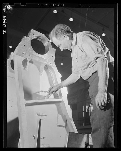 Production. Naval gun mounts. A big naval gun mount chassis is coated with aluminum paint before proceeding to assembly operations in a Midwest plant. Westinghouse, Louisville
