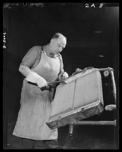 Conversion. Auto radiators to army helmets. Before a large Eastern manufacturer of automobile radiators converted to war production, this workman's job was soldering radiator cores. His job now is welding rims on army helmets. McCool Radiator Company, Detroit, Michigan