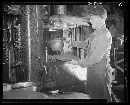 Conversion. Auto radiators to army helmets. An army helmet is formed from a flat piece of sheet steel in one operation at a drawing press in a converted Eastern factory. A short time ago this same press and operator were stamping out parts for automobile radiators. McCool Radiator Company, Detroit, 
