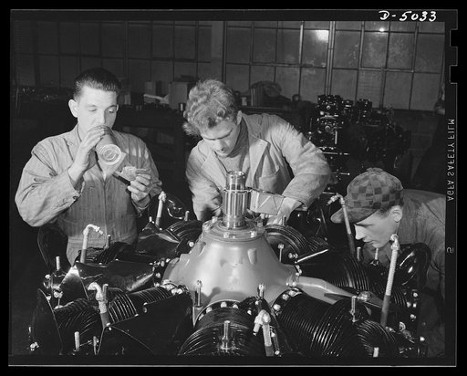 Production. Airplane engines. Reassembly of an airplane engine after subjection to rigid tests and minute examination of all parts in a Midwest plant. The reassembled engine will again be carefully tested and inspected before shipment to an airplane factory. Continental Motors, Michigan