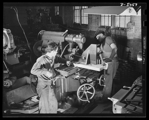 Subcontracting. Bogie-wheel assembly. Lining up a milling machine fixture in the shop of an Eastern subcontractor working on the production of bogie-wheel assembly parts. The particular operation shown is the milling of a slot in a rubbing plate. Painesville Machine Company