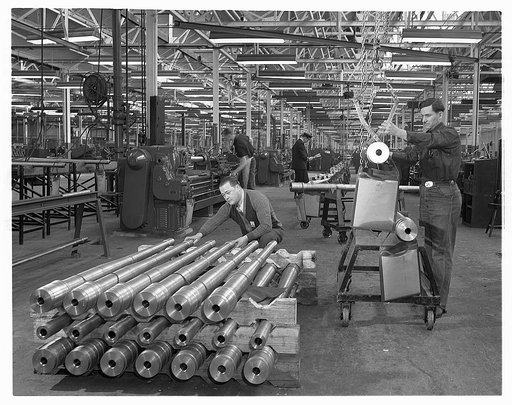 Conversion. Automobiles to 40 mm. anti-aircraft guns. 40 mm. anti-aircraft gun barrels produced in a former automobile plant. Those pictured above are about halfway through the manufacturing process. Chrsyler Corporation, Highland Park, Detroit