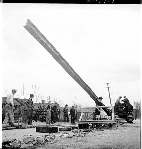 Buried trolley tracks salvaged to aid war program. Old tracks for new guns. One of the ways many American cities are responding to Uncle Sam's call for scrap is by pulling out abandoned trolley tracks. This apparatus, developed by an Asheville, North Carolina machine shop operator, is being used to 