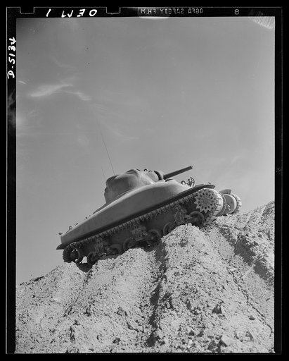 Testing M-4 tanks. One of America's new traveling forts, an M-4 tank, makes a trial run over the test hill of an Eastern manufacturing plant