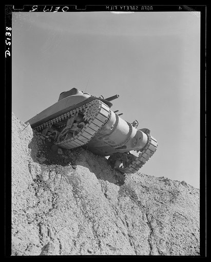 Testing M-4 tanks. A battleship of the land, one of America's mighty M-4 tanks, tops the ridge of a test hill as trial runs are made at an Eastern manufacturing plant