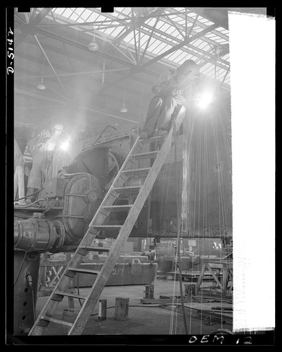 Production. M-4 tanks. Hull members of an M-4 tank on a "positioner" in the welding ship of an Eastern manufacturer. The M-4 marks a new advance in America's production of heavy armored equipment