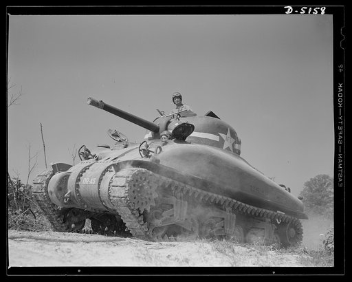 In the massive cast-steel hull of this M-4 tank, a crew of hard-bitten "tankers" is rehearsing a few fighting tricks at a training school of the armored forces at Fort Knox, Kentucky