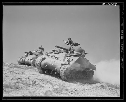 Fort Knox. M-4 tanks and crews. In the new M-4 tanks (right), the designers and the engineers got together to provide fighting advantages over and above those of the older M-3 tanks (left). Location: Fort Knox, Kentucky