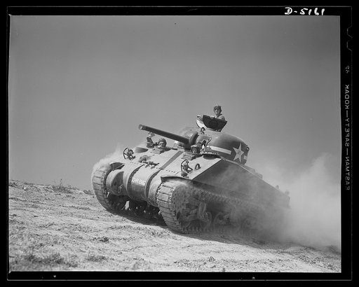 One of our new battleships of the land, a mighty M-4 tank that will disturb a lot of Axis plans. In the welded hulls of these massive machines is armament that ensures tremendous firepower in the hands of tough, resourceful "tankers." Location: Fort Knox, Kentucky