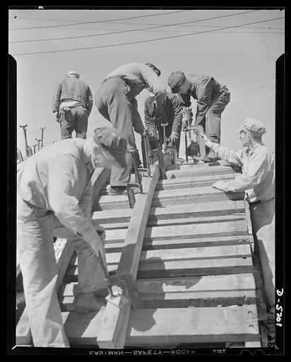 Production. Minesweepers. Forming ribs for minesweepers. By clamping timbers to a mold, these carpenters in an Eastern shipyard obtained the curved shapes required to serve as ribs for one of Uncle Sam's new minesweepers. Gibbs Cass Company