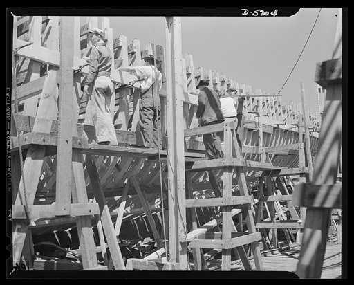 Production. Minesweepers. Shipbuilders setting the ribs of one of Uncle Sam's new minesweepers in an Eastern yard. Some of these men had been house carpenters, but readily adapted to their new work. Gibbs Cass Company