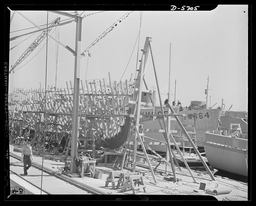 Production. Minesweepers. The frame of a new minesweeper takes shape in an Eastern shipyard. Two complete vessels of the same type ride in the water, awaiting final fitting before putting to sea. Gibbs Cass Company