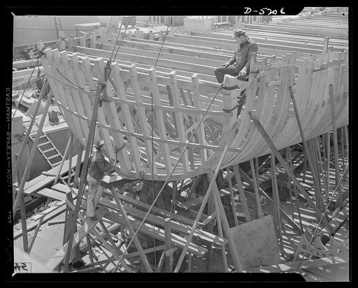 Production. Minesweepers. Stern view of the frame of a new minesweeper under construction in an Eastern shipyard. After the sturdy ribs have been planked over and a power plant installed, the hull will be ready for launching. Gibbs Cass Company