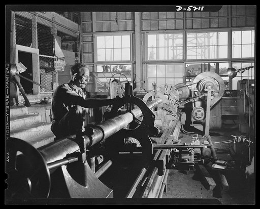 Production. Minesweepers. A veteran of the last world war operates a lathe that turns out tail shafts for minesweepers under construction in an Eastern shipyard. Gibbs Cass Company