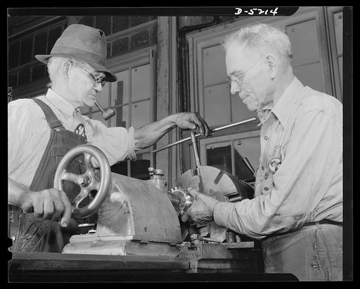 Production. Minesweepers. Grandad's doing a grand job. Two grandfathers, both seventy, D.L. Zimbrough and F.M. Webb, work on nearby lathes in an Eastern shipyard now turning out minesweepers for the Navy. The yard has kept up an excellent production by bringing many older workers out of retirement. 
