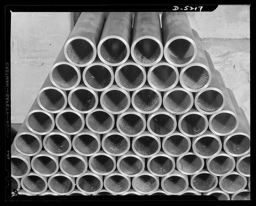 De Land pool. Carr's Machine Shop. These steel sleeves, machined to perfection, soon will be part of aircraft repair assemblies, a portion of the Carr shop's contribution to the De Land, Florida pool contract