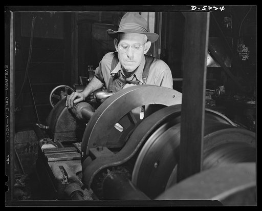 De Land pool. Bits and parts. With a "know-how" skill developed in thirty-two years experience as a machinist, Fred W. Casey, sub-contractor in the De Land, Florida pool, bends over a heavy lathe as it machines a part for the nation's war machine. Fifty-two-year-old Casey, like many machinists who r
