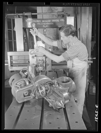 Subcontracting. Passaic home workshop pool. A worker in the Passaic, New Jersey machine shop of the Howe Machinery Company changes a milling head to a planer head on a planing machine, to convert it from production of one type of essential war production to another