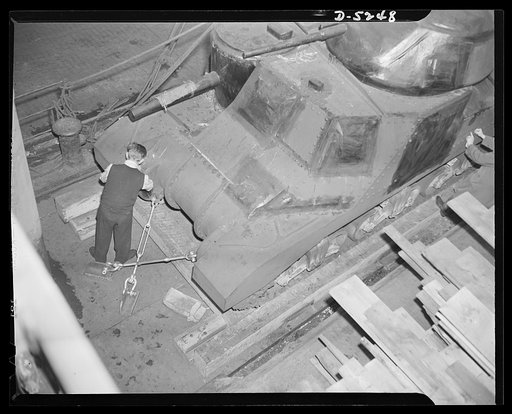 How lend-lease strikes at the Axis. An American tank on the deck of a cargo ship bound for the fighting fronts with lend-lease weapons. The tank is prevented from shifting at sea by clevises and turnbuckles attached to plates welded to the steel deck