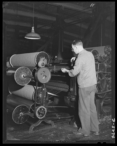 Salvage. Wool reclamation. Spinning wool yarn in an Eastern wool reclamation plant. This operation draws the roving and puts a twist in it to toughen the fibers and increase the tensile strength of the yarn