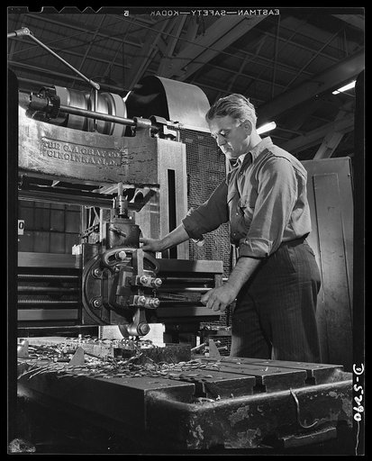 Production. Aircraft. This worker on America's battle line of production shows all the grim intent of purpose one would expect to find in the trenches on Bataan and in the gun emplacements of Corregidor. He operates a Gray milling machine in a large Western aircraft plant