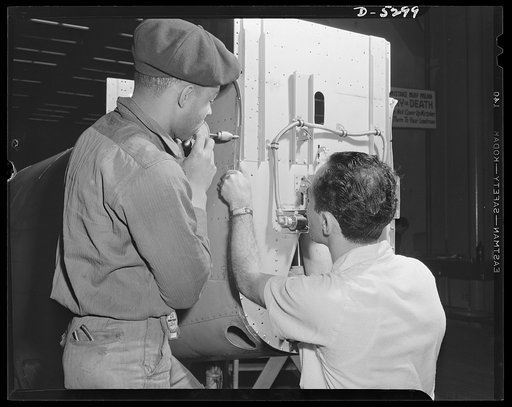 Production. Aircraft. On the tail section of a Ventura bomber, a Negro and a white worker team up to raise the production rate of a big Western aircraft plant