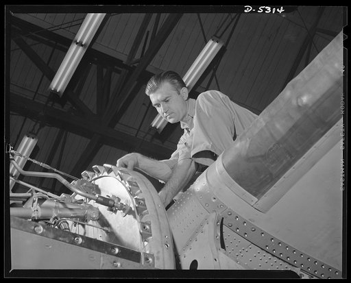 Production. Aircraft. Final assembly line of the Vega Aircraft Corporation. A mechanic makes a final check-up on a Ventura bomber