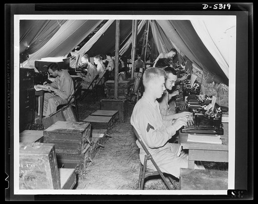 Forty-two keys to victory. Somewhere in the field with the U.S. Army, comprehensive clerical work is carried on between maneuvers. Unless those typewriters not essential to the war effort are turned in by civilians to Uncle Sam, the shortage of sufficient machines may materially cripple the speed an