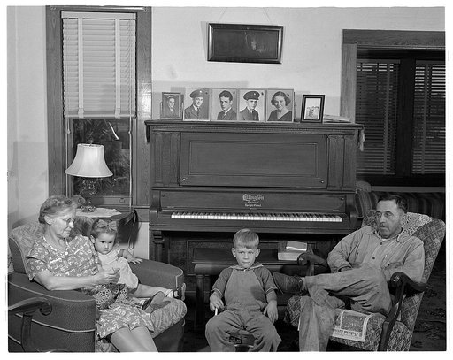 De Land pool. La Roe shop. The La Roe family of Eustis, Florida, after a day's work for the De Land pool. Left is Mrs. La Roe with her two-year-old granddaughter, next is four-year-old Eugene, Clarence La Roe's son, and Mr. La Roe