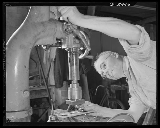 De Land pool. Skilled craftsmen. Can southern workers do close-tolerance machine work? Ask A.E. Kenyon, pictured above as he operates a machine turning out war material for the De Land, Florida pool. He's been a toolmaker since 1895 in some of the biggest plants in the country. He retired to Florida