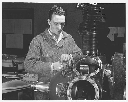 De Land pool. Aircraft construction class. Ken Kirkpatrick, eighteen, of Daytona, is typical of the hundreds of Volusia County youngsters who are preparing to take their places on Florida's production front. Enrolled in the Daytona Beach Vocational School, he's learning the watchmaker's precision ne