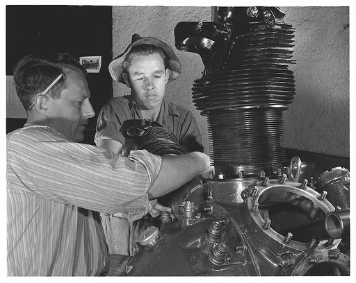 De Land pool. Aircraft construction class. Instructor Gil Angell shows Ernest Williams, high school student, how to install a cylinder on an aircraft engine in the Daytona Beach, Florida Vocational School that is turning out hundreds of workers for Florida's war production program