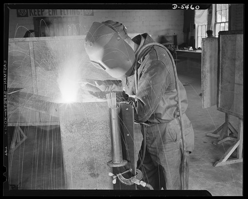 De Land pool. Aircraft construction class. Behind the mask this arc welder wears at the training school of the De Land, Florida pool is the face of one of the townsmen, familiar to many in the community as a barber, salesman, taxi driver or gas station attendant. Soon he'll be working on one of the 