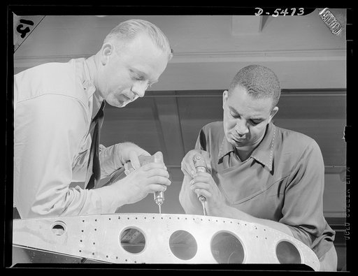 Training. Brooklyn Aviation Center. At the Brooklyn Aviation Trade Center, a student mechanic and an instructor work side by side using identical tools and performing identical operations on wing sections. The same method is employed in training beginners to work on other jobs in plane construction