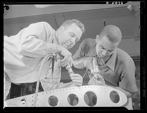 Training. Brooklyn Aviation Center. At the Brooklyn Aviation Trade Center, a student mechanic and an instructor work side by side using identical tools and performing identical operations on wing sections. The same method is employed in training beginners to work on other jobs in plane construction
