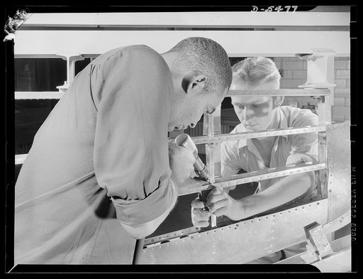 Training. Brooklyn Aviation Center. At the Brooklyn Aviation Trade Center, a student mechanic and an instructor work side by side using identical tools and performing identical operations on wing sections. The same method is employed in training beginners to work on other jobs in plane construction