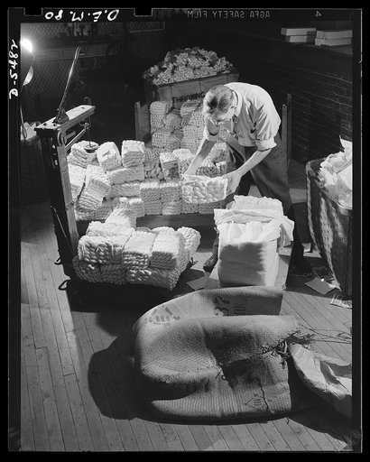 Production. Parachute cloth and shrouds. This raw silk used in manufacturing parachute cloth and shroud lines was reeled in China or Japan. The operator is removing the covering and checking the weight of a Japanese bale